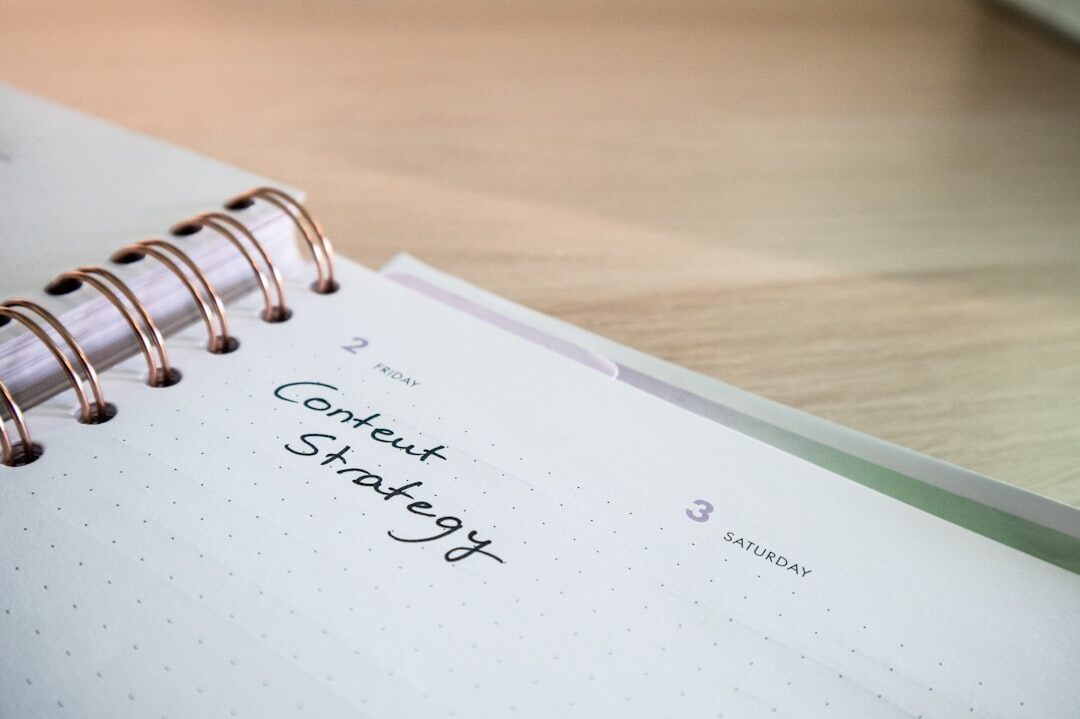 person writing in journal at desk