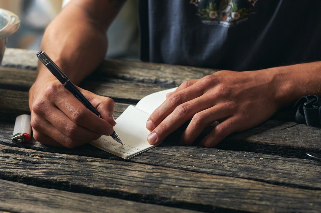 person writing goals on paper